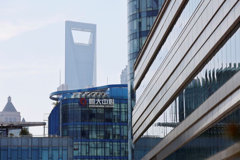 Asian tech shares jump, China property stocks rally as Evergrande makes payment