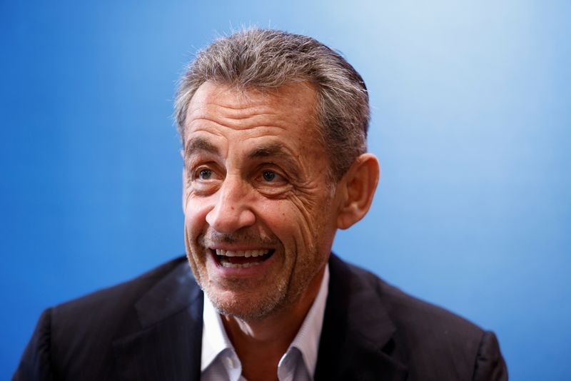 France's Sarkozy plays down new conviction at book signing event