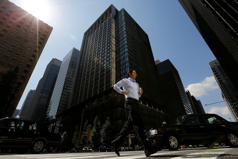 Japan business mood improves as firms raise investment plans