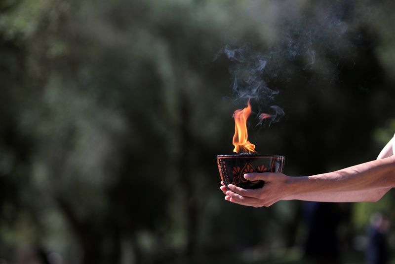Olympics-Protest disrupts Beijing Games torch-lighting ceremony