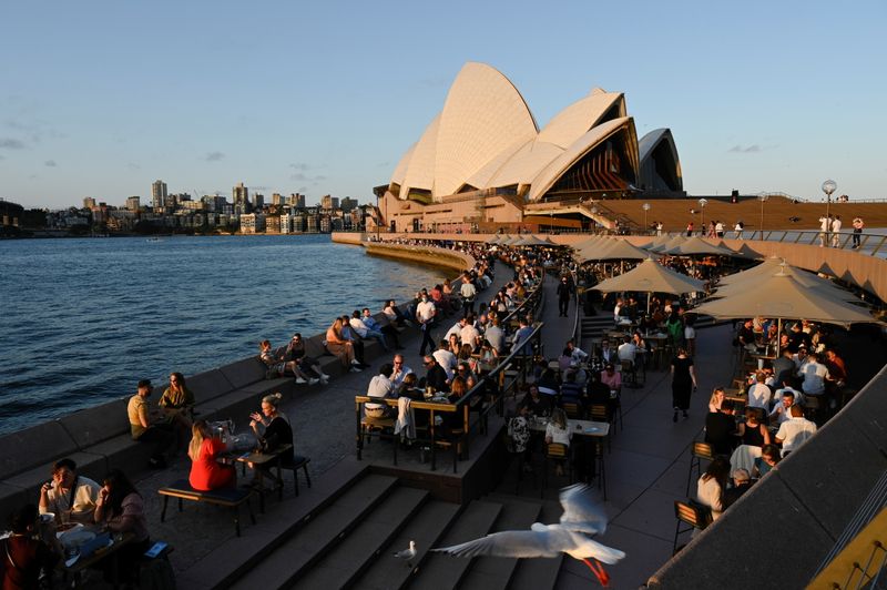 Australia begins vaccine booster rollout as more curbs ease in Sydney