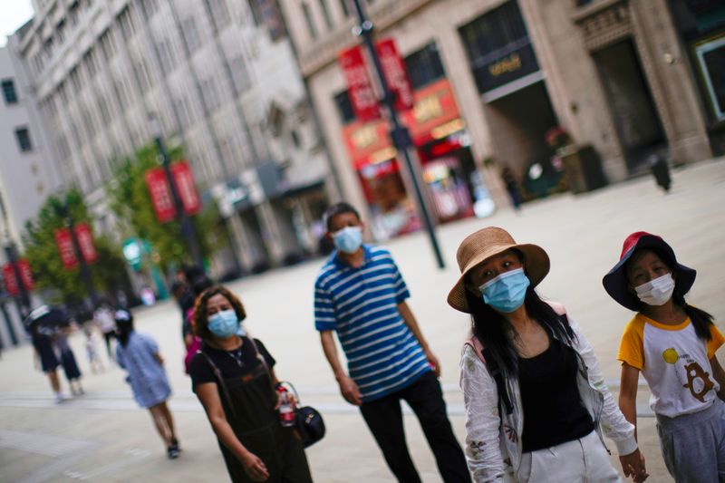 Shanghai cuts tourism, eastern Chinese city limits transport on resurgent COVID