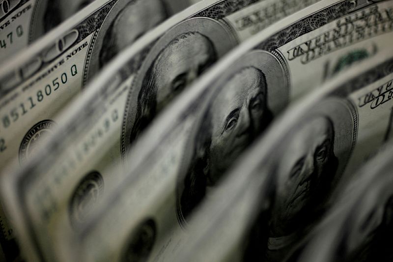 Dollar steady as traders wait for central banks, pound inches lower on COVID fears