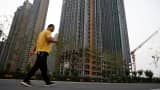 A man walks in front of unfinished residential buildings at the Evergrande Oasis, a housing complex developed by Evergrande Group, in Luoyang, China September 15, 2021. Picture taken September 15, 2021.