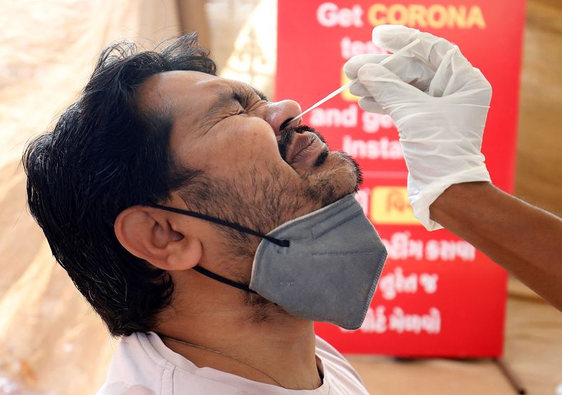 Masks come off, rallies begin as India's COVID-19 patient load falls