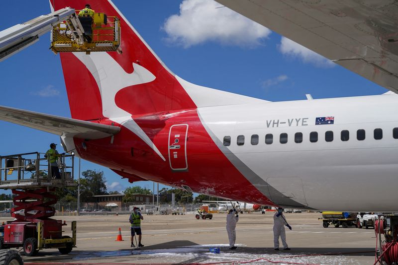 Qantas says competition to intensify, will report large H1 loss