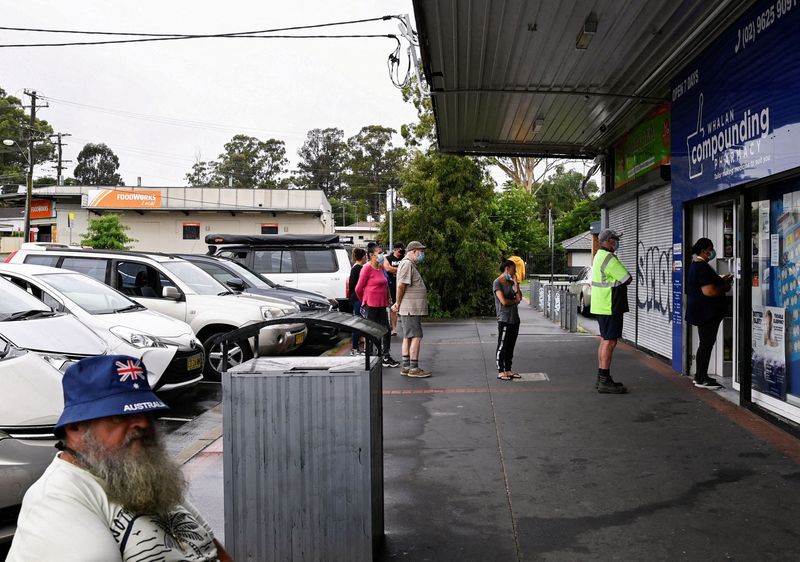 Australia swamped by Omicron surge as pressure grows on hospitals
