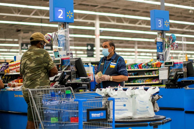 Exclusive-Walmart halves paid leave for COVID-positive workers, extends hybrid work guidelines