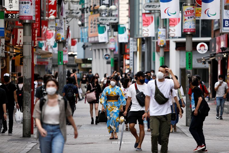 Japan's economy rebounds on solid spending, Omicron clouds outlook