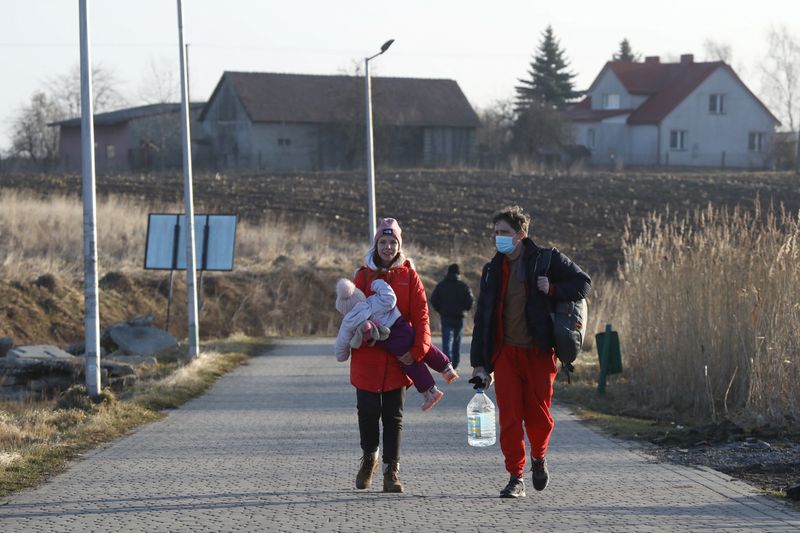 Leaving behind possessions and pets, Ukrainians flee to Poland