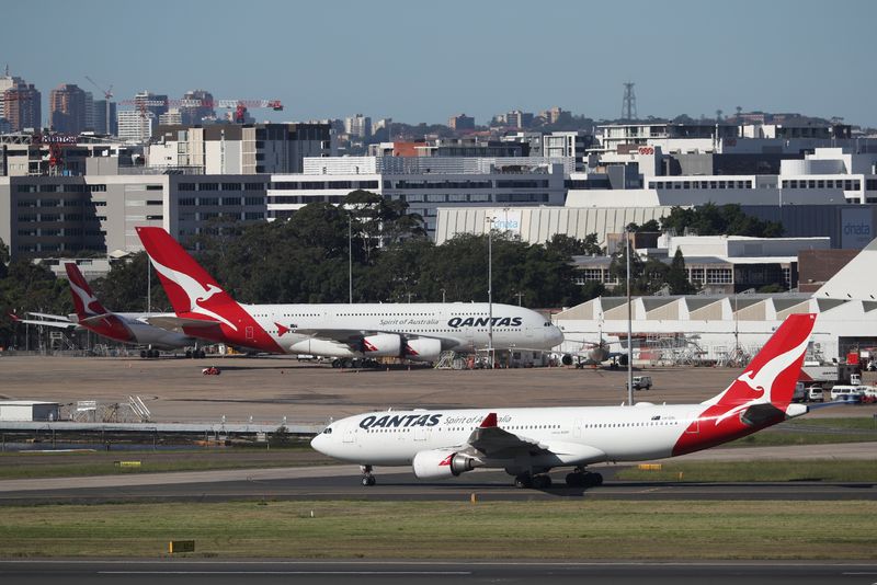 Qantas posts deeper H1 loss but says outlook improving