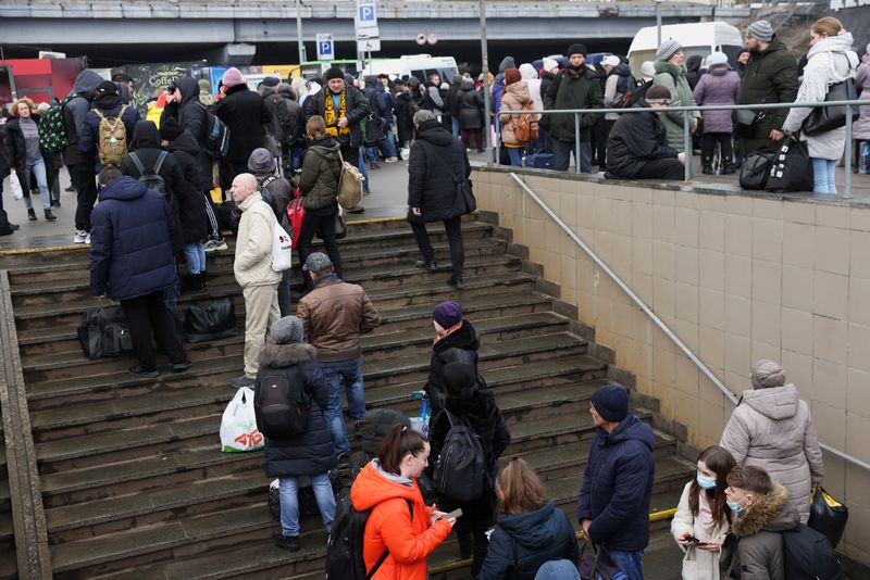 Some Kyiv residents try to flee, others stock up after Russia attacks