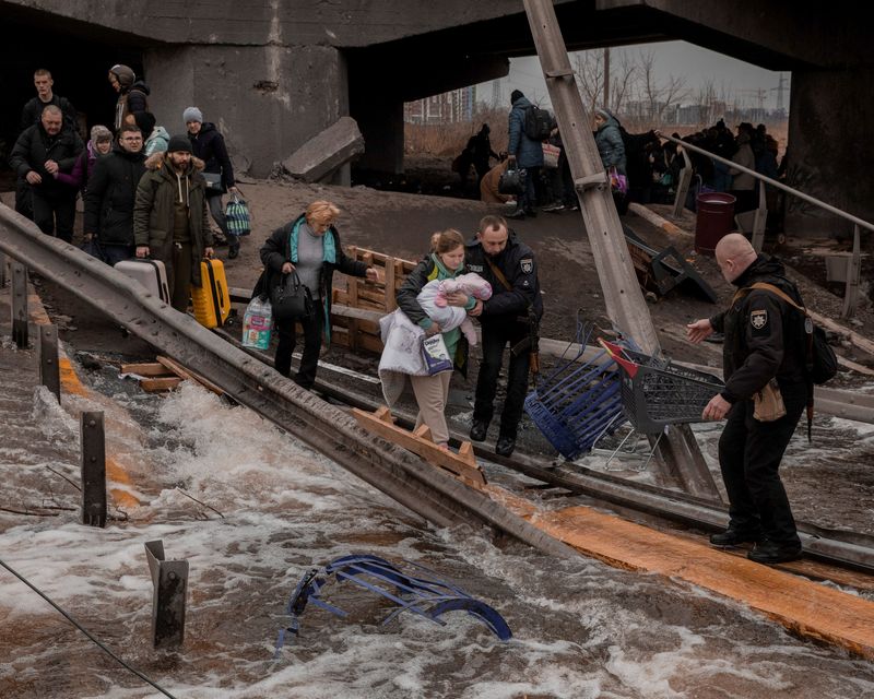 Ukrainians flee some besieged areas through 'humanitarian corridors'