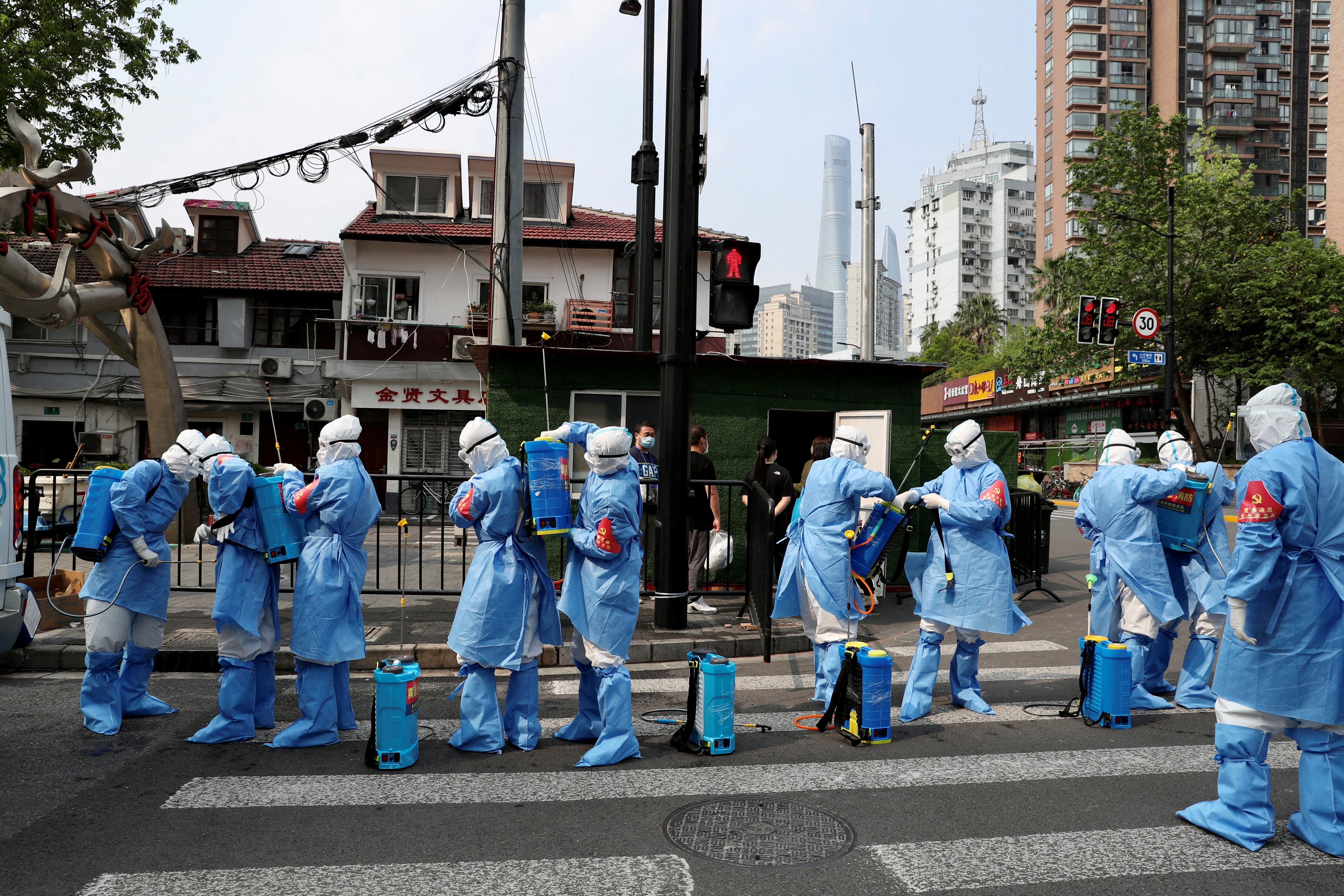 Shanghai to keep COVID curbs as infections outside quarantine rise again