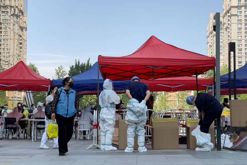 Some in Shanghai come out for air as Beijing resumes mass COVID tests