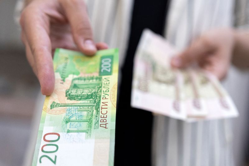 Russian rouble eases towards 62 vs dollar, stocks fall